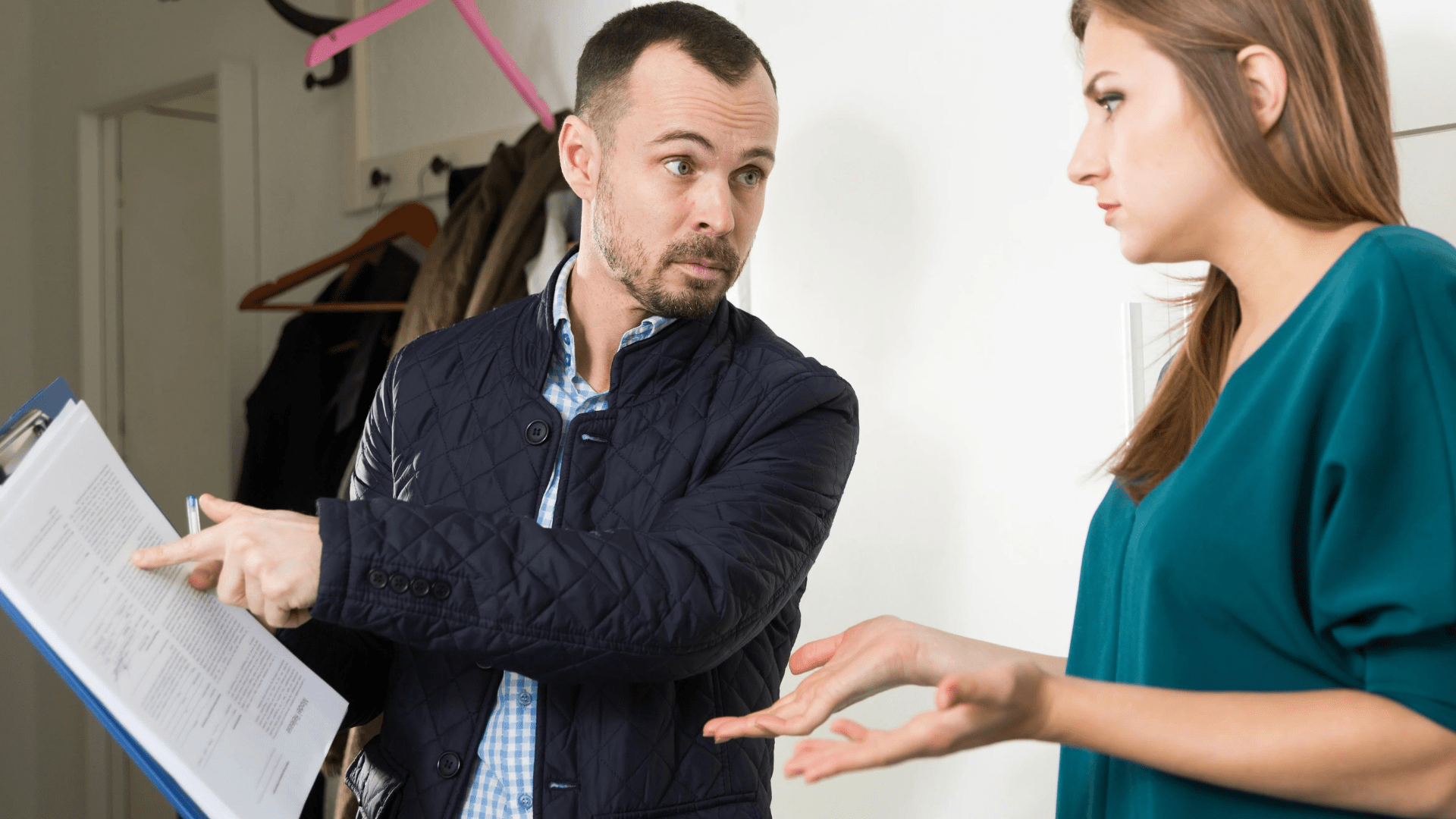 Man pointing to document, engaging in discussion with concerned woman.